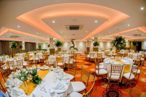 a wedding banquet hall with white tables and chairs at Mandarina Colombo in Colombo