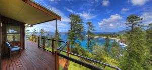a balcony of a house with a view of a river at Endeavour Lodge in Burnt Pine