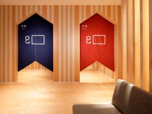 a room with two elevators with red and blue at hotel androoms Nagoya Sakae in Nagoya