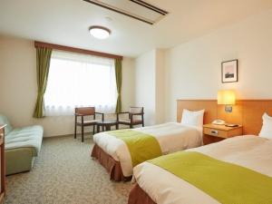 Postel nebo postele na pokoji v ubytování Hotel Familio Minakami