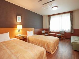 Postel nebo postele na pokoji v ubytování Hotel Familio Minakami