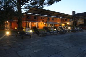 a group of chairs sitting on a patio at night at Hotel Van Gogh in Saint-Rémy-de-Provence