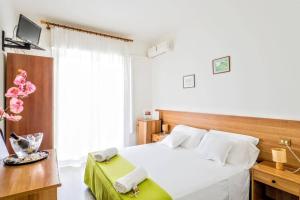 Postel nebo postele na pokoji v ubytování Pensione Imperia