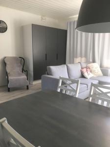 a living room with a couch and a table at Paljakka Villas in Kotila