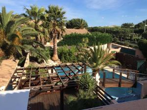 arial view of a resort with a pool and palm trees at Le Mas Des Oliviers in Agde