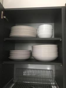 a group of plates and bowls in a cabinet at Paljakka Villas in Kotila
