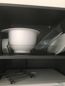 a white bowl and other dishes on a shelf at Paljakka Villas in Kotila