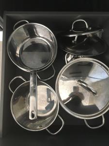 a box with four pots and pans on a stove at Paljakka Villas in Kotila