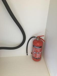 a fire extinguisher in the corner of a room at Paljakka Villas in Kotila