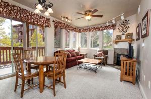 a living room with a table and chairs and a couch at Crestview Condominiums in Park City