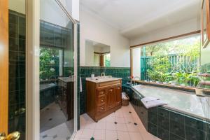 a bathroom with a tub and a large window at Country Pleasures Bed and Breakfast in Angaston +12 photos