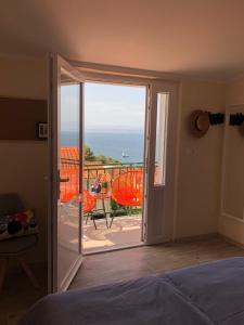 a bedroom with a door open to a balcony at Villa Olyntha in Stomorska