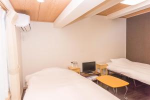 Postel nebo postele na pokoji v ubytování Ryokan Hinomoto Kyoto Kawaramachi