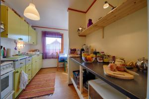 a kitchen with green cabinets and a counter top at Kongsfjord Holiday Home in Kongsfjord