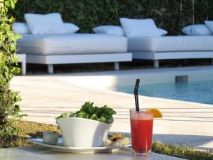 a drink on a table next to a bowl of food at Atlántico Boutique Hotel in Punta del Este