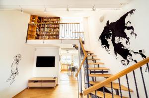 salon ze schodami i telewizorem na ścianie w obiekcie 4BR 3BATH BALCONY central Harry Potter penthouse w Pradze