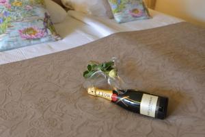 a bottle of wine on top of a bed at Hotel Residentie Slenaeken in Slenaken