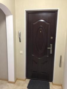 a black door in a hallway with a phone at Apartments Kharkivs'ke highway in Kyiv