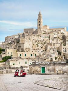 a car parked in front of a large city at Palazzo Gattini Luxury Hotel in Matera