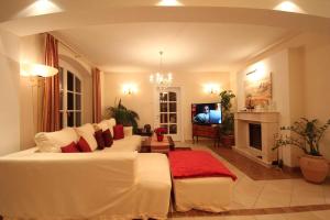 ein Wohnzimmer mit einem weißen Bett und einem TV in der Unterkunft Villa Wellness Homes in Mötz
