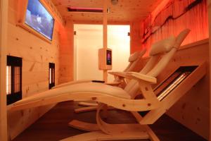 a room with a gym with a chair in it at Villa Wellness Homes in Mötz