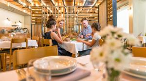 um grupo de pessoas sentadas numa mesa num restaurante em Hotel Polanica Resort & Spa em Polanica-Zdrój