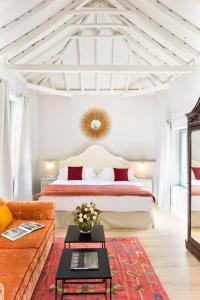 a bedroom with a large bed and a couch at Palacio Bucarelli in Seville