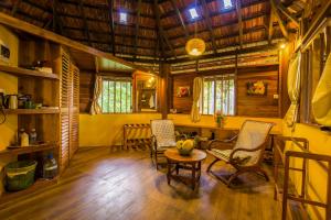 
a living room filled with furniture and a fireplace at Palm Paradise Cabanas & Villas Beach Resort in Tangalle

