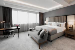 a hotel room with a bed and a desk and a chair at InterContinental Sofia by IHG in Sofia