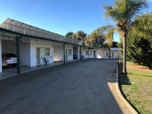 an empty street in front of a building at Green Door Motel in Albury