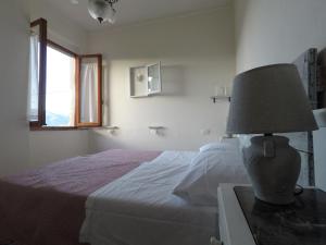 a bedroom with a bed and a lamp on a table at Casa della nonna Filò in Beverino