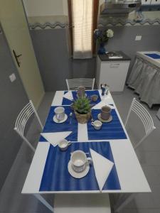 a dining room table with a blue and white table cloth at Casa della nonna Filò in Beverino +27 photos