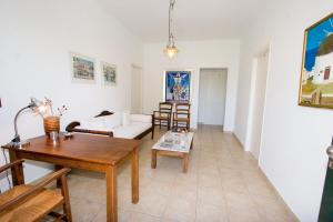 a living room with a table and a couch at Soile Georgia in Loutra Edipsou