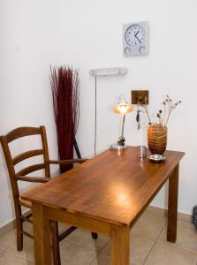 a wooden table with a lamp and a chair at Soile Georgia in Loutra Edipsou +22 photos