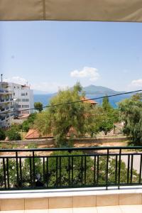a balcony with a view of the water and trees at Soile Georgia in Loutra Edipsou