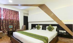 a bedroom with a large bed and a large window at Treebo Trend Edge St Marks Road in Bangalore