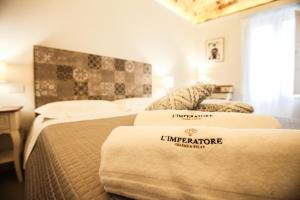 Postel nebo postele na pokoji v ubytování L'IMPERATORE Relax & Charme