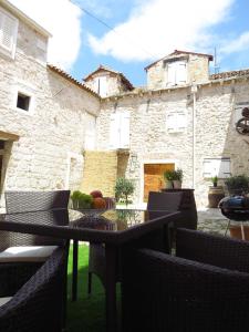 a patio with a table and chairs in front of a building at Apartman Brunela in Šibenik