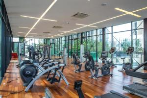 a gym with a bunch of treadmills and ellipticals at The Shore Residence Apartment in Melaka
