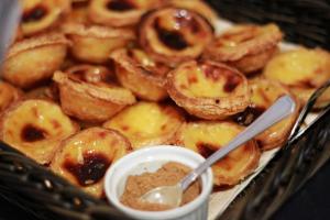 a tray of donuts with a bowl of dipping sauce at Real Marina Hotel & Spa in Olhão