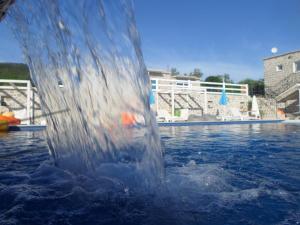 a water fountain in the middle of a swimming pool at Luštica Apartments in Luštica