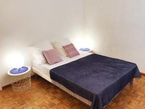 a bedroom with a bed with two pillows on it at Le Solemar in Cassis