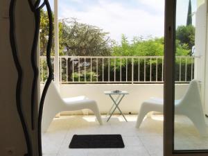 a view of a balcony with two chairs and a table at Le Solemar in Cassis