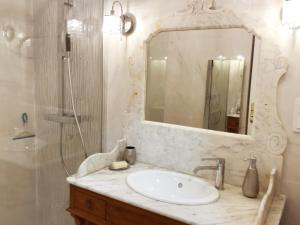 a bathroom with a sink and a shower and a mirror at Le Solemar in Cassis +25 photos