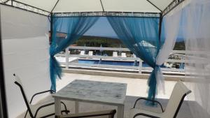 a patio with a table and chairs and a window at Luštica Apartments in Luštica