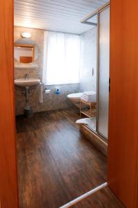 a bathroom with a sink and a mirror at Landgasthof Schlüssel Alpnach in Alpnach