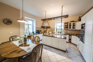 a kitchen with a table and a dining room at Penzion Jasmín in Liberec