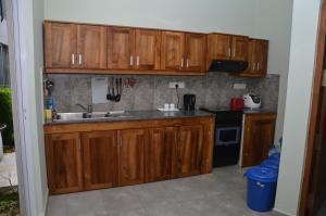 a kitchen with wooden cabinets and a sink at Kelaniya Heritage in Kelaniya