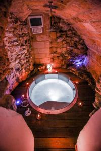 a bath tub in a stone room with lights at L'IMPERATORE Relax & Charme in Altamura