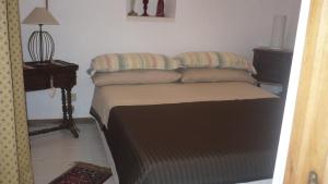 a bed with two pillows on it in a room at Trullo Mauro MGG - Trullo Fragale in Martina Franca